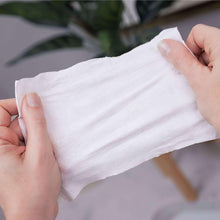 White flushable wipe sheet held between hands
