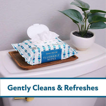 Flushable wipes pouch opened with tissue pull, blue-and-white patterned case