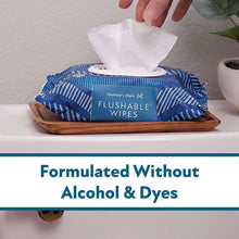 Flushable wipes box with blue patterned wrapper and tissue pulled up
