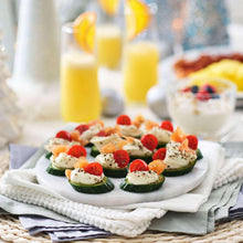 Seasoned appetizer bites on a platter with herbs and pink salt garnish