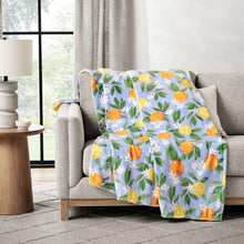 Lounge throw blanket in light blue with orange lemon and green leaf pattern