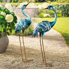 Metal crane statues, set of 2, blue and silver birds with long gold legs.