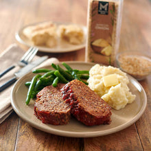 Minced onion seasoning jar beside a plated meal with green beans and garlic pieces