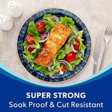 Blue patterned paper plate with salmon, greens, and sliced vegetables