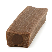 Brown dog chew bone with dark interior end, angled side view