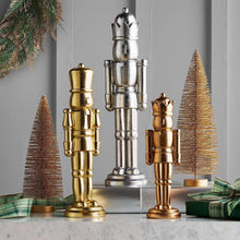 Nutcracker decor set: silver, gold, bronze nutcrackers with mini pine trees