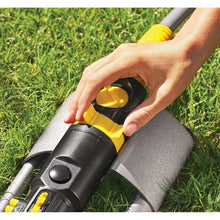 Oscillating lawn sprinkler spray head with dial adjusted by hand in green lawn