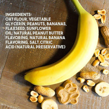 Banana and peanut dog treats with paw-shaped cookies on a wooden surface