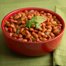 Red bowl of pinto beans with parsley garnish
