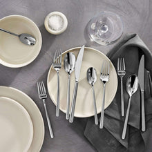 Stainless steel flatware set with modern handles, silver finish on table setting