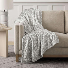 Gray lounge throw blanket with small repeating floral-dot pattern