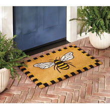 Coir doormat with large bee illustration and black-and-yellow checker border