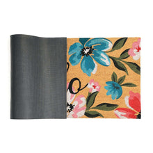 Coir doormat rolled view with floral panel showing “Hello”