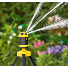 Telescoping tripod sprinkler with yellow head and steady arc spray, on black legs