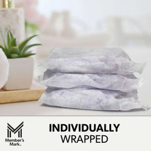 Individually wrapped long absorbent pads stacked on a surface