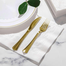 White 3-ply dinner napkins on place setting with gold forks and leaves
