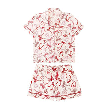 Flat pajama set: short-sleeve button top and matching elastic-waist shorts, red bow print