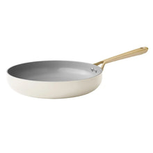 Cream ceramic frying pan with long handle and metal rivets