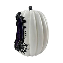 White ribbed pumpkin with purple and black spiderweb trim and dangling spider