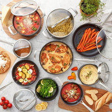 Nonstick cookware set with lids off, dark gray pots and pans filled with food