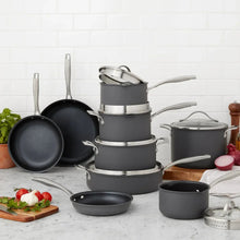 Stacked nonstick aluminum cookware set in dark gray with stainless rims and lids