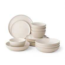 Stacked stoneware dinnerware set in light taupe with bowls, plates, and cups