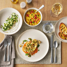 Stoneware dinnerware set with white plates, bowls, and cups for everyday dining