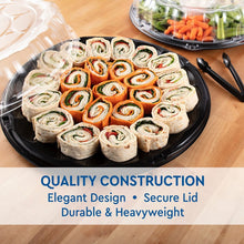 Round black catering tray with clear lid holding assorted prepared wraps and sliced food