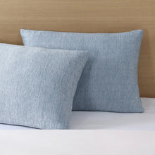 Blue cooling pillow set, front and side view on white bedding