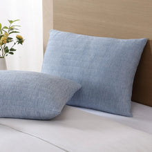 Light blue cooling pillow with textured fabric and visible seam stitching at edge