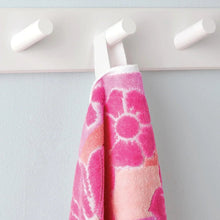 Pink and white kids beach towel with abstract graphic shapes and loop patterns