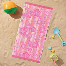 Kids beach towel in pink with orange and white tropical flower pattern.