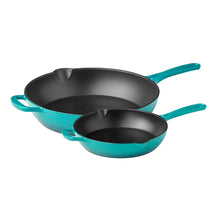 Enamel cast iron skillet set with two teal pans, black interiors, and side handles