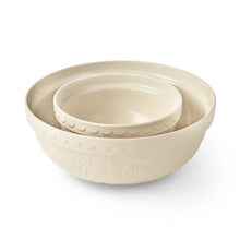 Ceramic prep and serve bowl in cream, round with embossed floral detail and scalloped edge