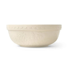 Cream ceramic prep bowl with embossed floral vines and scalloped rim, side view
