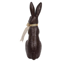 Chocolate bunny décor with gold belt ribbon wrap, facing right in seated pose