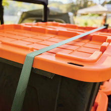 Orange-lidded storage tote with green strap handle and textured lid surface