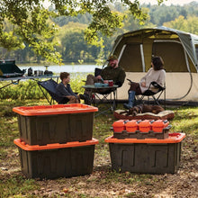 Heavy-duty storage tote stack outdoors with orange lids, dark plastic body