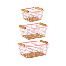 Set of three pink wire storage baskets with wooden shelf supports.