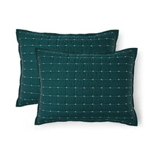 Two teal pillow shams with stitched grid pattern and matching buttonhole edging