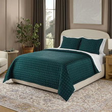 3-piece quilt set on bed with teal quilt and two matching patterned pillow shams