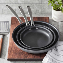 Hard anodized fry pans set showing three nested black nonstick pans