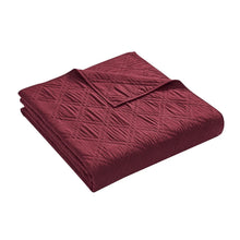 Merlot diamond-quilt bedding comforter, neatly folded with visible stitched pattern