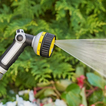 Handheld spray nozzle releasing a fine water mist