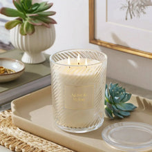 Ribbed glass candle jar with Agave & Melon label and three wicks, clear-white glass