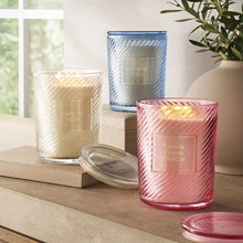 Three ribbed glass candles with labels: Agave & Melon, Nantucket Waves, Passion Flower Hibiscus
