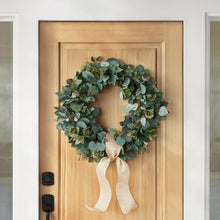 Eucalyptus wreath with dense green leaves and cream hanging bow