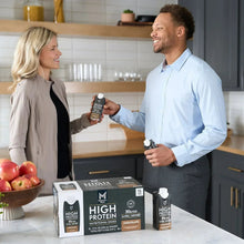 High protein nutritional shake chocolate cartons on counter during product handoff