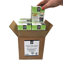 Cardboard box of small trash bags being lifted by hand; multiple bags visible
