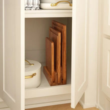 Acacia wood cutting board set stored upright in a cabinet with stacked boards